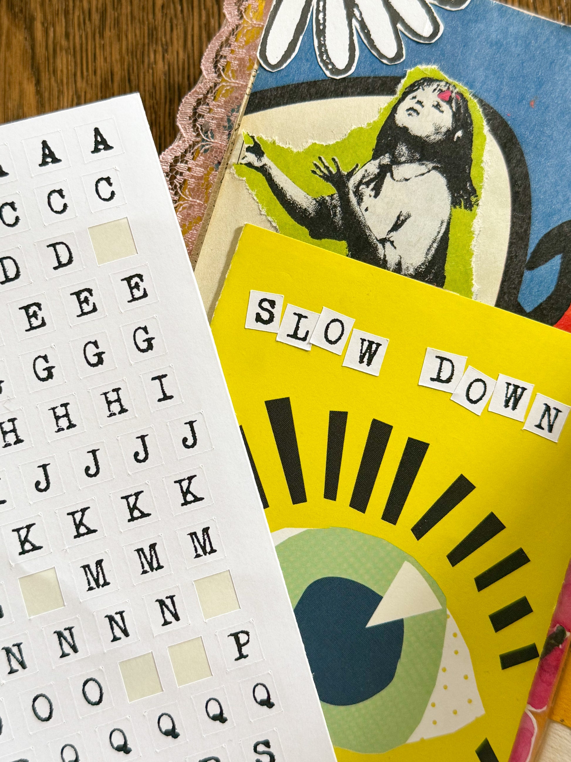 Junk journal page with typewriter alphabet stickers sayings 'SLOW DOWN'